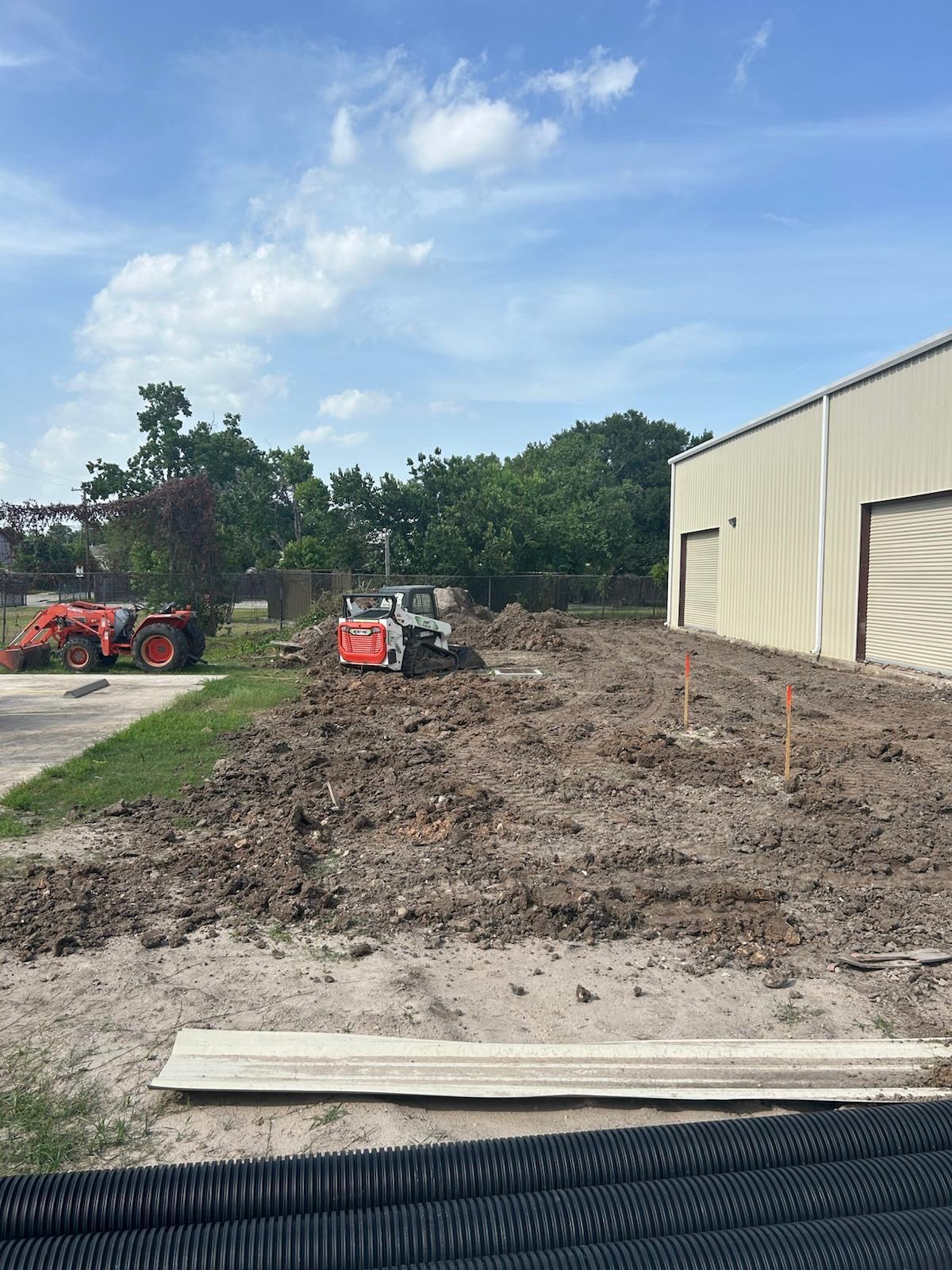 Skid steer grading building pad