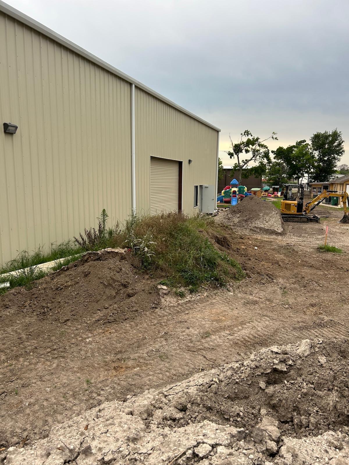 Sitework beside warehouse